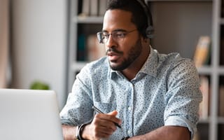 A tech worker wearing a headset on a remote job interview.