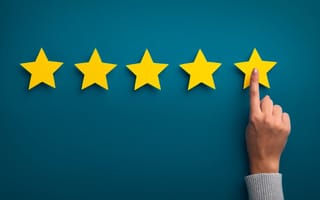 Woman's hand putting up a five star rating