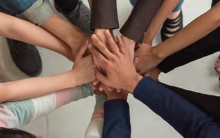 Close up of a group of people doing a team hand stack