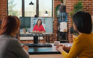 A remote job interview with two interviewers speaking to one candidate.
