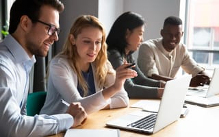 Interns learning corporate software from a mentor