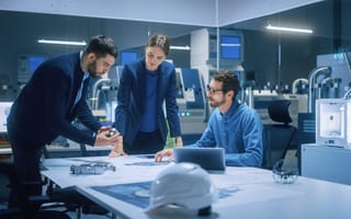 Three engineers working together to complete a project.