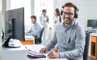 A customer success manager chats with a customer over the phone.