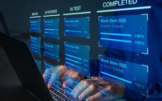 Software developer using Kanban board framework methodology on computer
