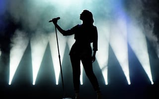 silhouette of a singer singing into a microphone