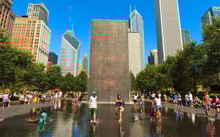 Visitors enjoying the popular Crown Fountain on a beautiful summer day in Millennium Park in downtown Chicago