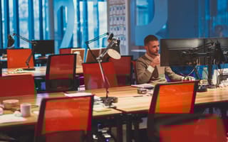 A person working alone at a growing office.
