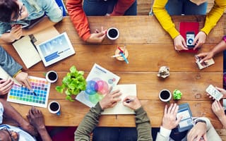 group of designers brainstorming around a table