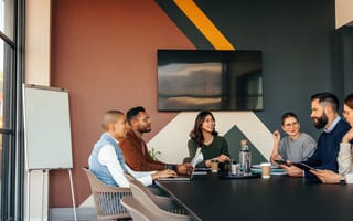 A team meeting in a conference room to discuss work.