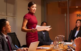 A team meeting led by a woman in management.