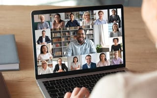 Back view of a person talking with colleagues on a video call