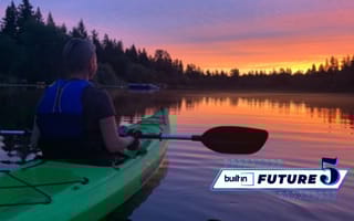Limitless Guided Visualization's CEO Cali Chill in a kayak at sunset.
