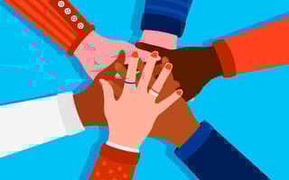 Hands of divers peole stacked on top of each other in a commitment to DEI Initiatives.