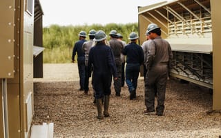 Crusoe Energy Systems’ staff walking through an outdoor facility