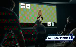 A Swerve Fitness instructor leading a group cycling class via livestream.