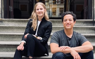 Perygee co-founders Mollie Breen, CEO, (left) and Mark Watabe, CTO, (right) sitting on the steps outside of a building.