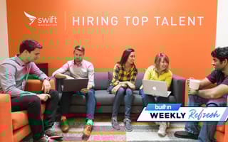Members of the Swift Navigation team working and chatting in an orange office