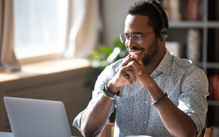 A customer success manager chats with a customer over the phone.