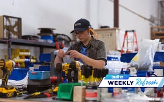 An AMP Robotics employee holds a plastic bag