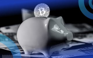 A Bitcoin being slotted into a piggy bank.