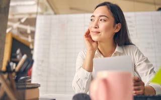 Photo of a person looking contentedly off to the side in an office.