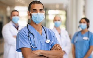 A group of nurses wearing face makspose for a photo