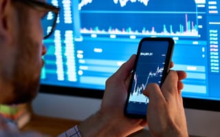 Investor looking over digital currencies on a phone.