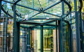 A revolving door in a glass building.