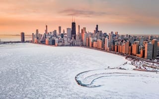 The Chicago skyline sits behind a snow covered lake