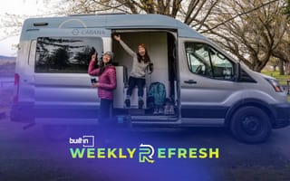 Two people showcase the exterior of a Cabana camper van.