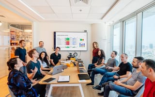 Monday.com’s leadership team in a board room.