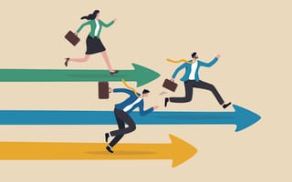 three business people racing each other while carrying briefcases