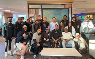 The Ballislife team gathers around a table.
