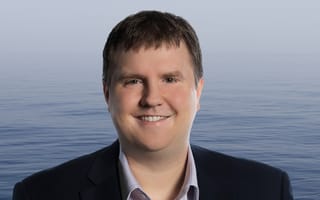 Greg Newbloom, Membrion's CEO, poses for a photo against a water background.