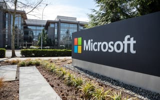 Wide angle view of a Microsoft sign at the headquarters for the software and hardware company, with office building in the background