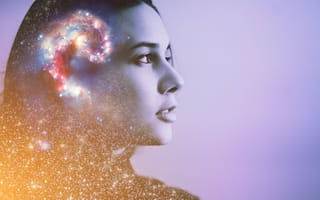 Abstract image of universe and stars overlaid on head of woman's side profile