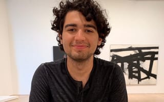 Tavrn Founder Pedro Paulino poses for a photo in an art exhibition.