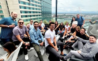 Quantive staff on a rooftop overlooking the city.
