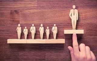 Wooden figurines depicting a leader and his team.