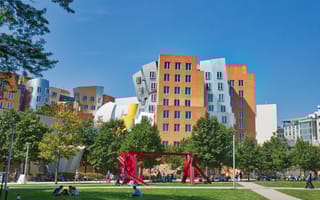 A red metal sculpture is pictured in front of the Stata Center on the MIT campus.