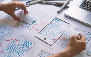 A designer works on user journey maps.