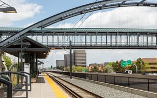 Lightrail tracks and a pedestrian bridge above a highway in the Denver Tech Center.