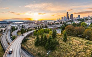A birds eye view of expressways and the Seattle skyline.