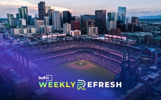 An aerial view of the Denver skyline and Coors Field at sunset.