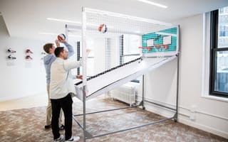 WSC Sports’ employees shoot hoops in the company’s new office.