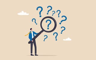 An illustration of a man holding a giant magnifying glass up to a question mark