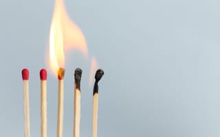 A cascade of burning matches, some burned and some yet unlit