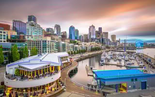 The Seattle pier and skyline at dusk.