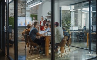 A manager presenting to employees in a conference room.
