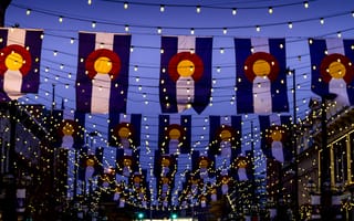 nighttime photo of colorado flags with string lights